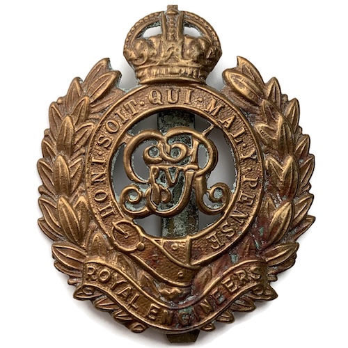 A non-voided gilt metal Royal Engineers headdress badge, the badge is shaped around the emblem which comprises GRV monogram within crowned Garter surrounded by a laurel wreath, there is a scroll below embossed with the name of the regiment 'ROYAL ENGINEERS', the badge is complete with a slider.
Inscription

GRV HONI SOIT QUI MAL Y PENSE ROYAL ENGINEERS