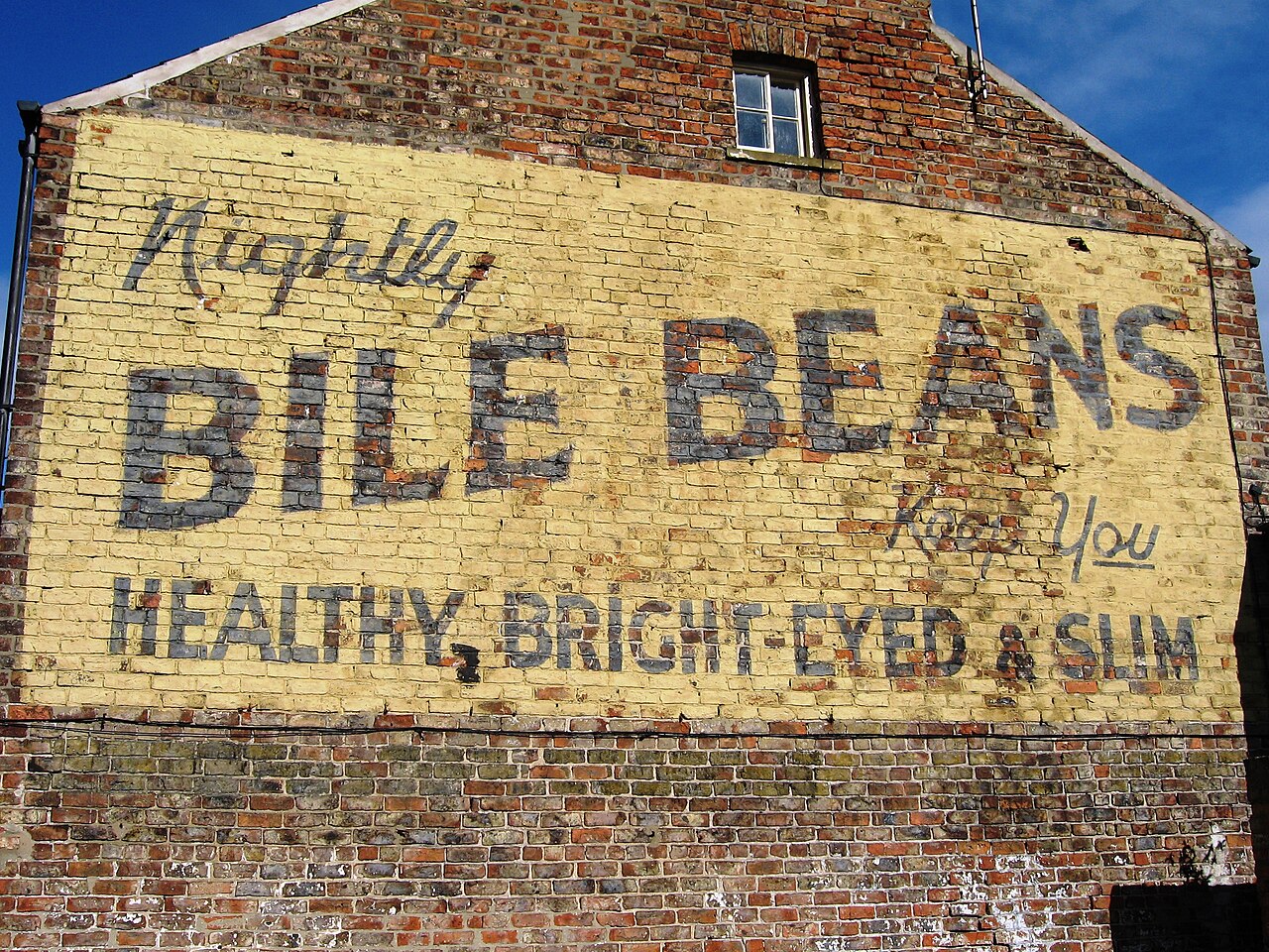 Nightly Bile Beans keep you healthy, bright-eyed and slim. Signwriting in York originally ~1930. Bile Beans Ghost Sign, Lord Mayors Walk, York.